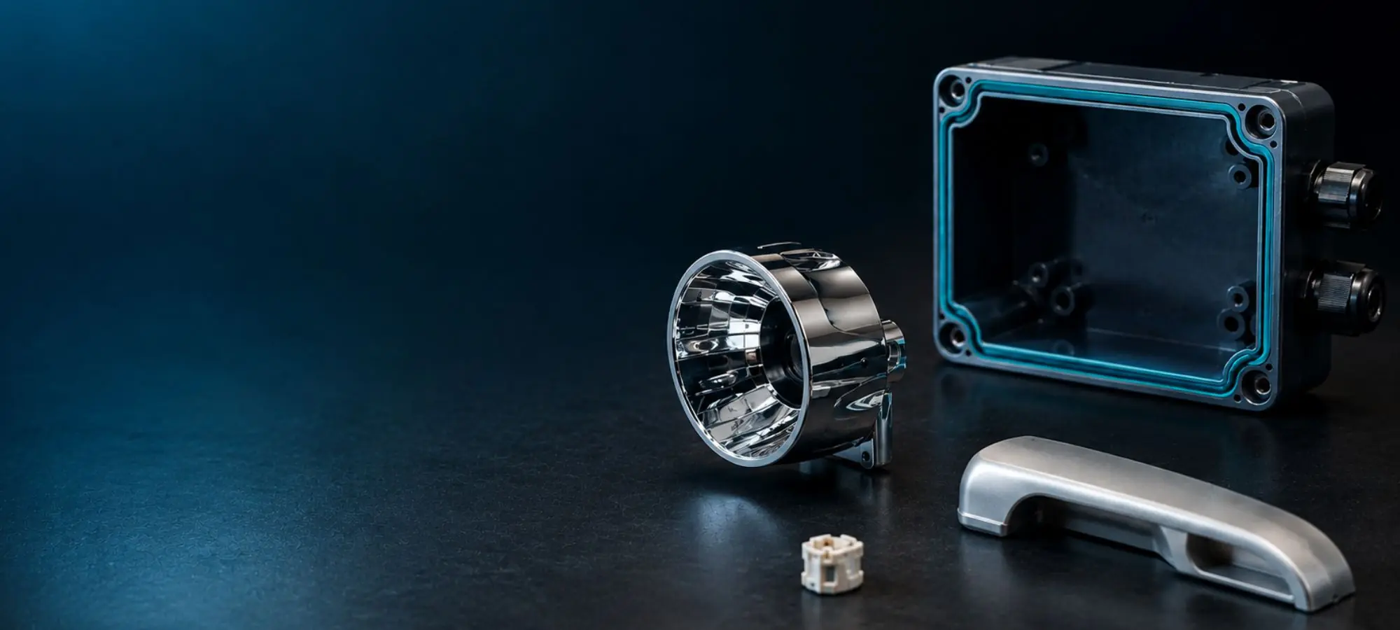 Finished plastic enclosure, metallized reflector and metal components