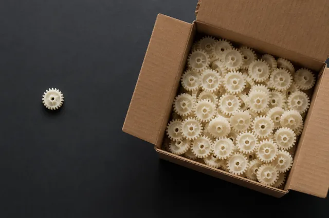 Moulded plastic components counted into a protective carton.