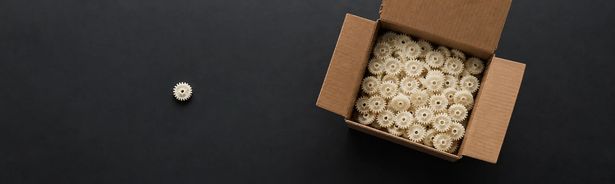 Box of injection-moulded plastic gears prepared for delivery